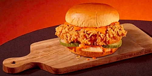 Police vehicles tow a detached car axle on a highway.