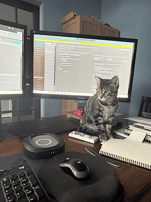Police vehicles tow a detached car axle on a highway.
